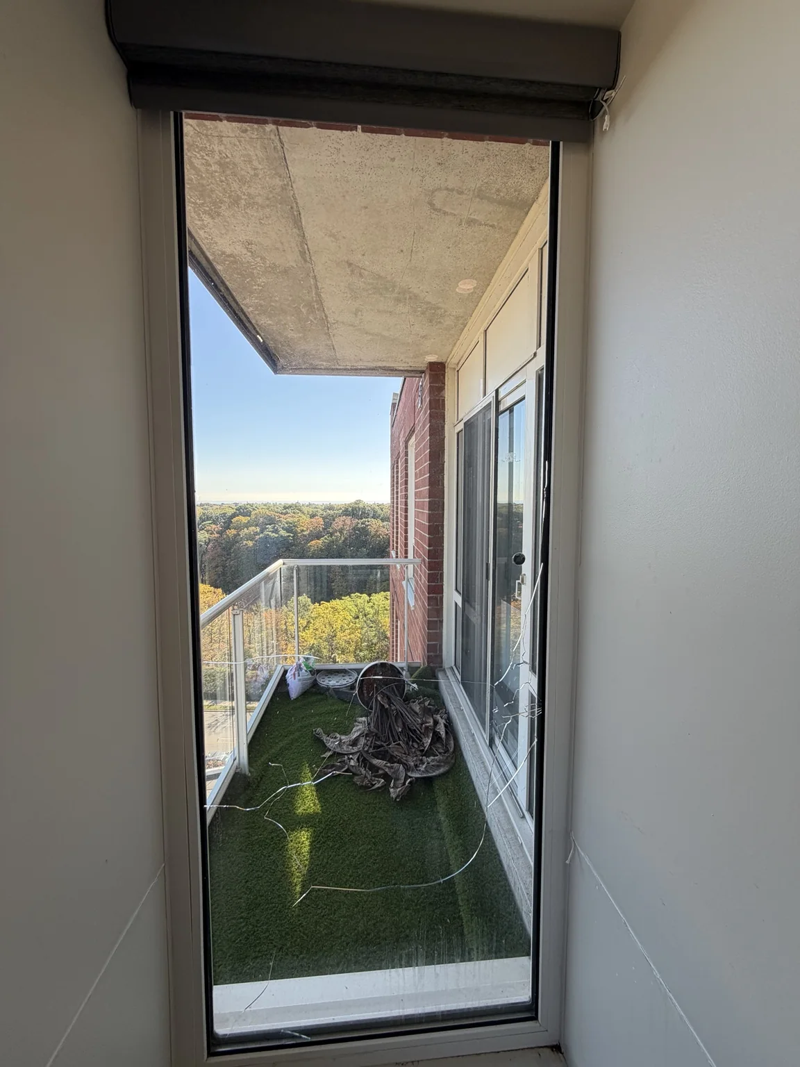 Cracked residential entry-door sidelite before replacement