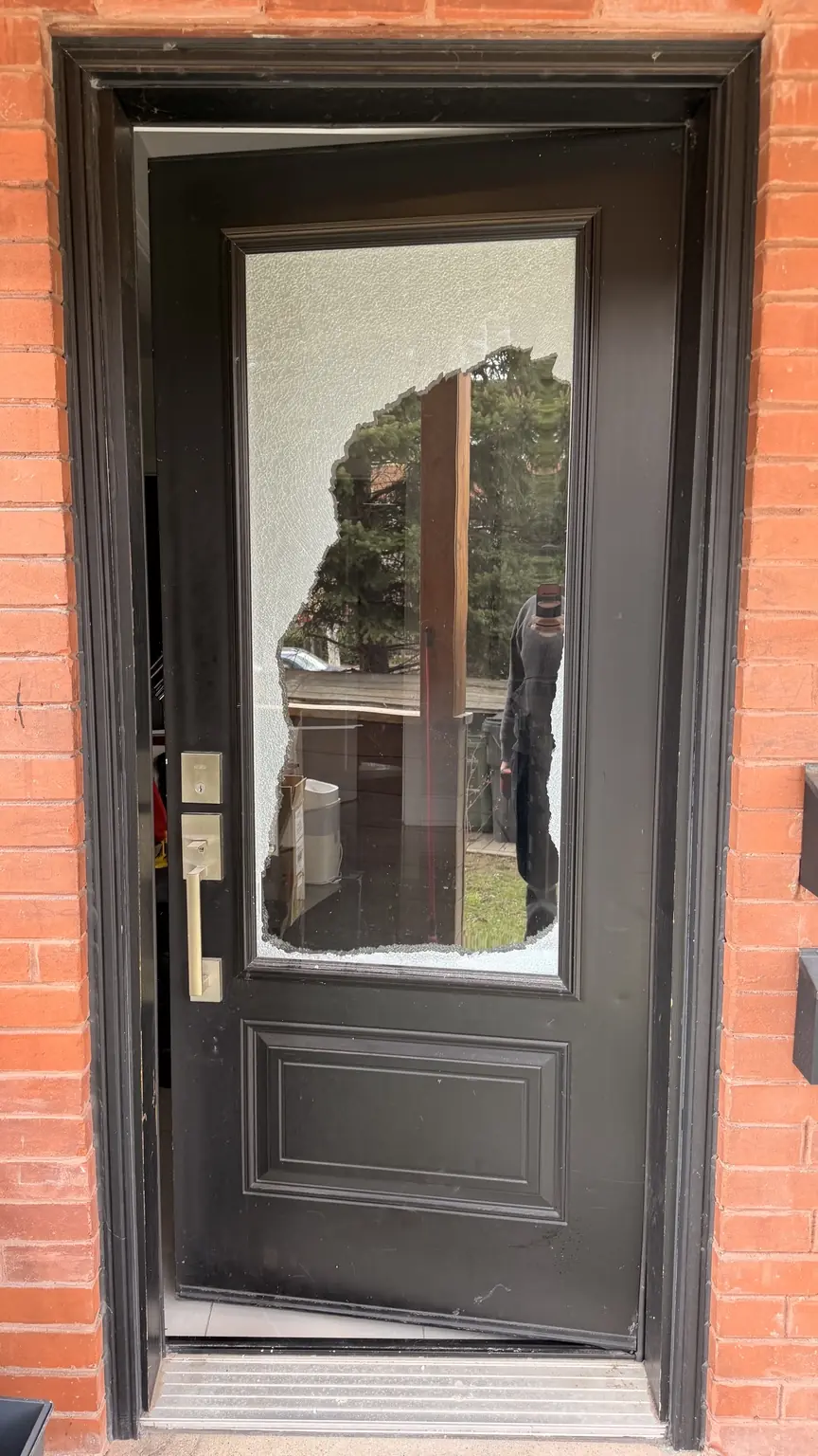 Toronto residential entry door with broken glass before replacement