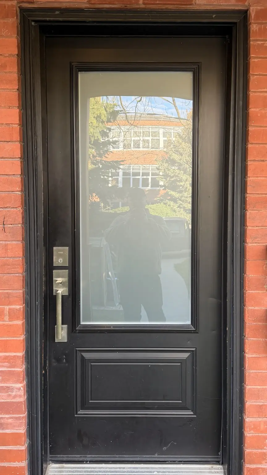Toronto residential entry door after replacement glass installation